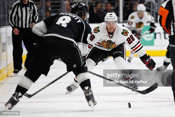 Ryan Garbutt of the Chicago Blackhawks defends against Drew Doughty of the Los Angeles Kings during a game at Staples Center on November 28, 2015 in...