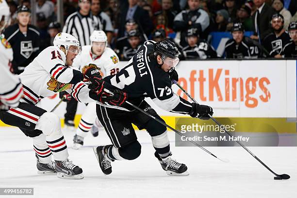 Jonathan Toews of the Chicago Blackhawks chases Tyler Toffoli of the Los Angeles Kings who skates with the puck during a game at Staples Center on...