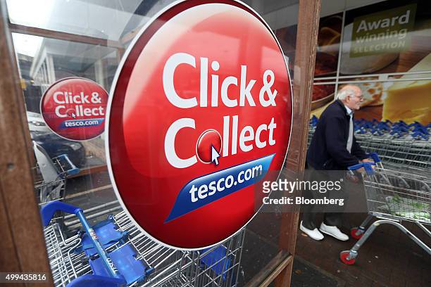 Sign advertising an online Click and Collect shopping service adorns a shopping trolley at the Tesco Basildon Pitsea Extra supermarket, operated by...