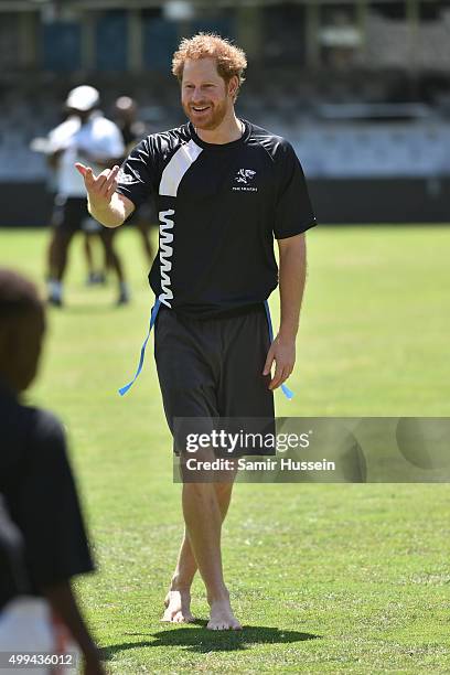 Prince Harry takes part in a rugby game with children at The Sharks rugby club at Kings Park Stadium during an official visit to Africa on December...