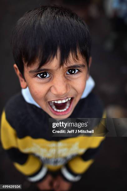 Young Iraqi boy poses for a photograph in the camp known as the 'New Jungle' on December 1, 2015 in Calais, France. Thousands of migrants continue to...