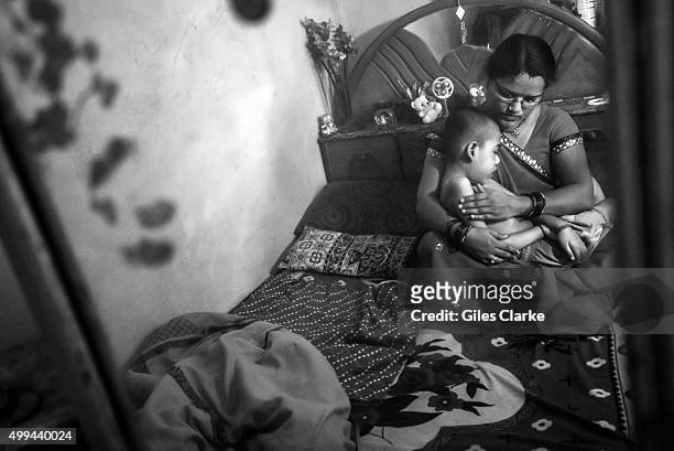 Rishikesh, 8 years old, with his mother Sangeeta at home in the Pushpa Nagar neighborhood. Rishikesh was born to parents contaminated by a...