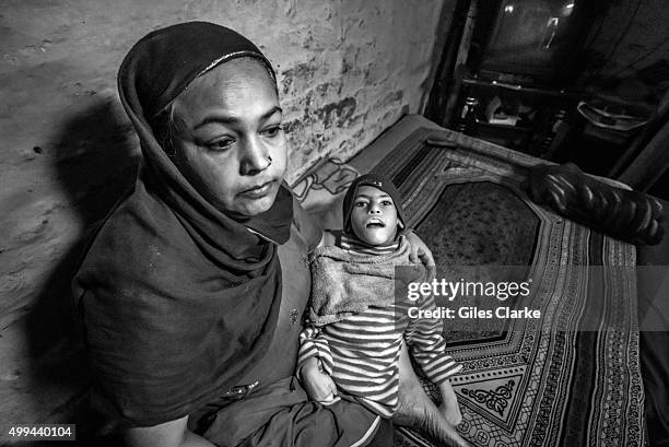 Sohaib, 10 years old, with his mother Firoza Bee at home in the Tila Jamalpura neighborhood. Sohaib was born to parents contaminated by a...