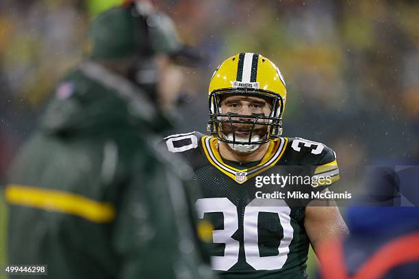 John Kuhn of the Green Bay Packers looks to get the play on the sidelines from Head Coach Mike McCarthy during the game against the Chicago Bears at...