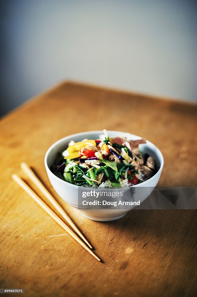 Bowl of chicken and vegetable stir fry and rice