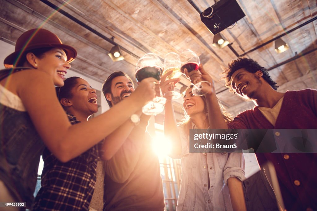 Below view of cheerful people having a toast.