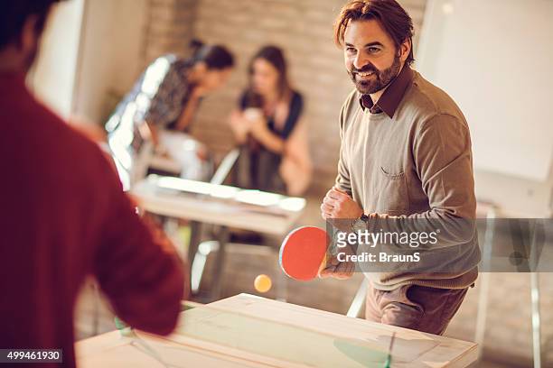 competition in playing table tennis at casual office! - office ping pong stock pictures, royalty-free photos & images
