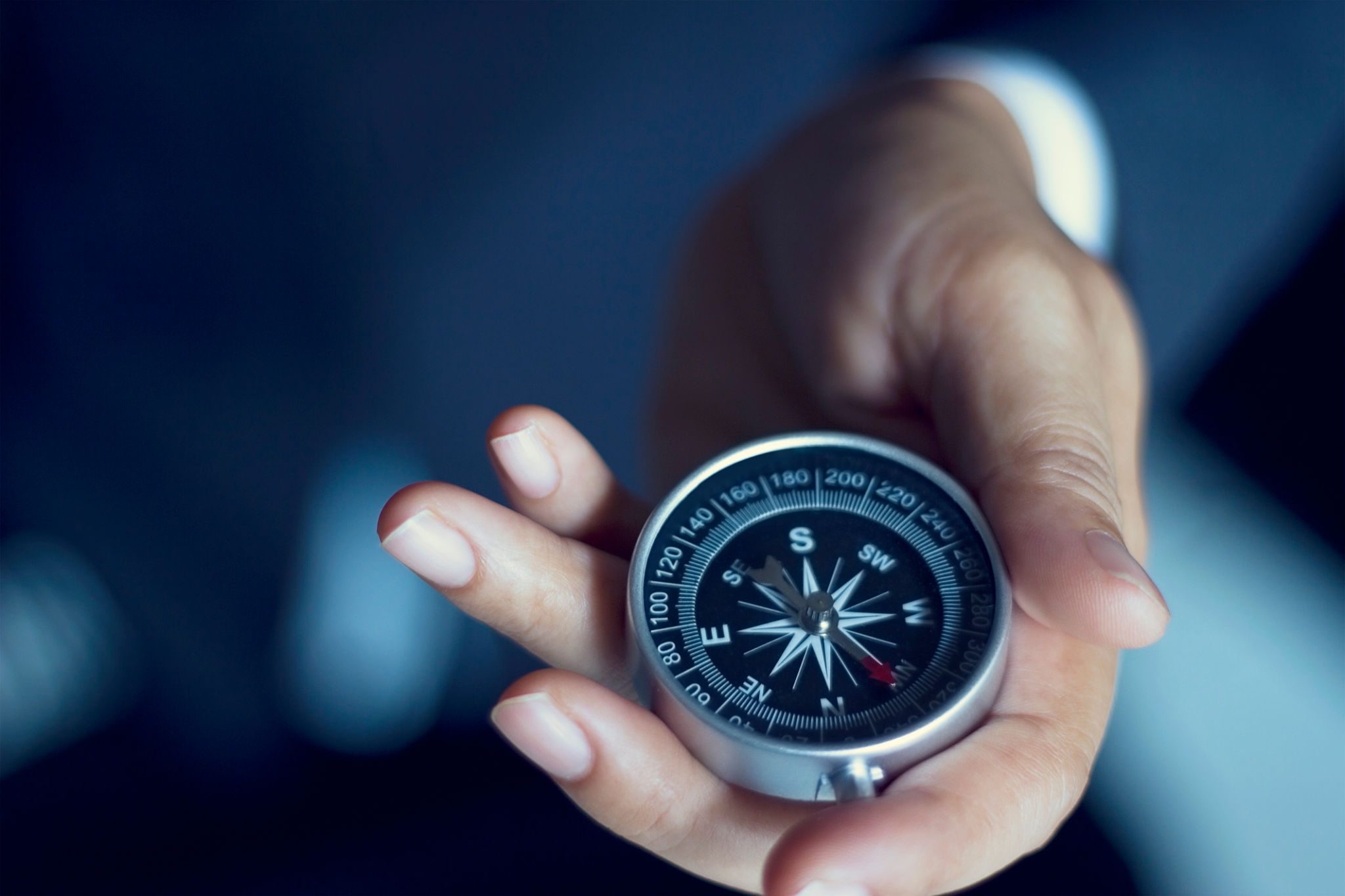 Businessman with a compass holding in hand Businessman with a compass holding in hand