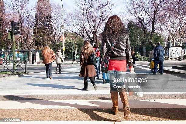 young woman on a crosswalk. - street style in madrid stock pictures, royalty-free photos & images