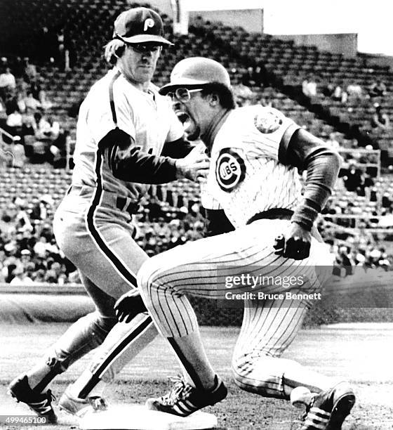 Leon Durham of the Chicago Cubs lets out a yell after being hit by the ball on his ankle as Pete Rose of the Philadelphia Phillies could not make the...