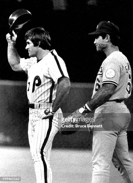 Pete Rose of the Philadelphia Phillies tips his helmet to the crowd after getting a base hit to place him fourth place on the all-time hit list with...