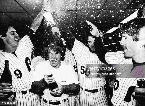 Von Hayes, Pete Rose, Marty Bystrom and Mike Schmidt of the Philadelphia Phillies celebrate in the locker room after defeating the Los Angeles...