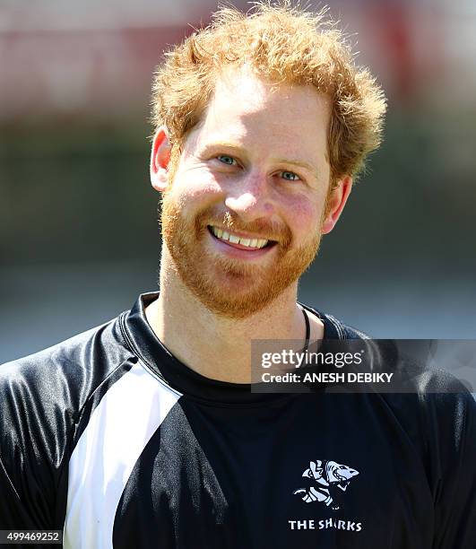 Britain's Prince Harry poses during a visit to the staff and management at the GrowthPoint Kings Park Stadium on December 1, 2015 in Durban. Prince...