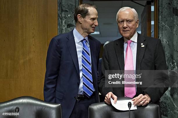 Senator Orrin Hatch, a Republican from Utah and chairman of the Senate Finance Committee, right, and Senator Ron Wyden, a Democrat from Oregon, left,...