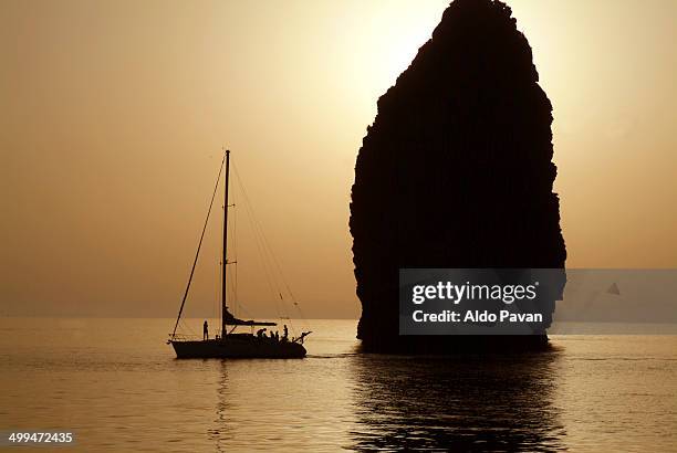 sailing at the sunset, lipari island, cliffs - isola di lipari foto e immagini stock