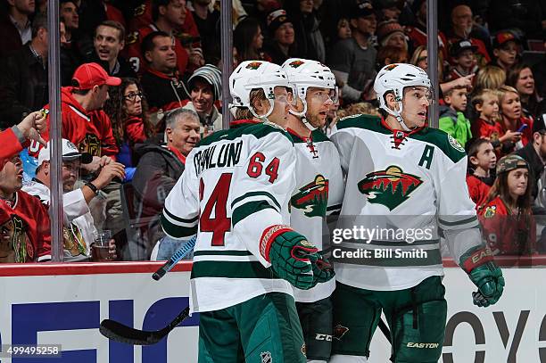 Jason Pominville of the Minnesota Wild celebrates with Mikael Granlund and Zach Parise after scoring against the Chicago Blackhawks in the first...