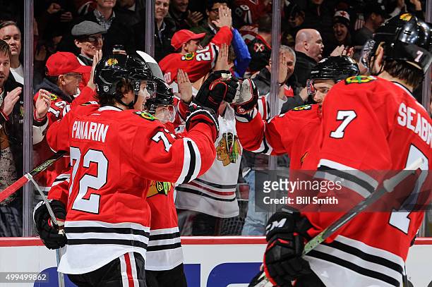 Patrick Kane of the Chicago Blackhawks celebrates with Artemi Panarin , Artem Anisimov and Brent Seabrook after scoring against the Minnesota Wild in...