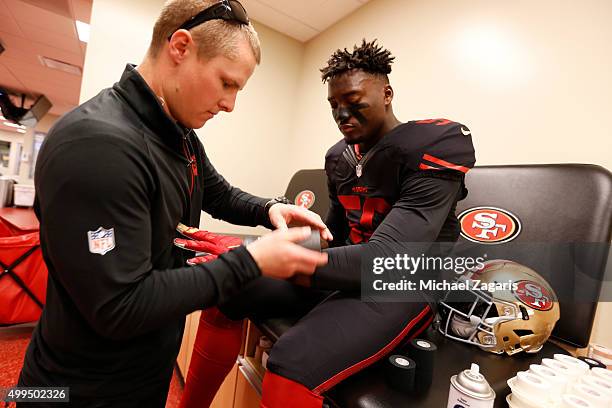 Eli Harold of the San Francisco 49ers gets taped up in the locker room prior to the game against the Arizona Cardinals at Levi Stadium on November...