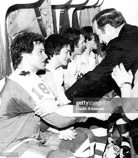 Head coach Red Kelly shakes hands with Jim McKenny and others after the Maple Leafs defeated the Pittsburgh Penguins in Game 3 of the Preliminary...