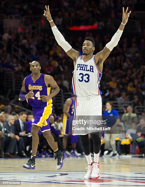 Robert Covington of the Philadelphia 76ers reacts in front of Kobe Bryant of the Los Angeles Lakers on December 1, 2015 at the Wells Fargo Center in...