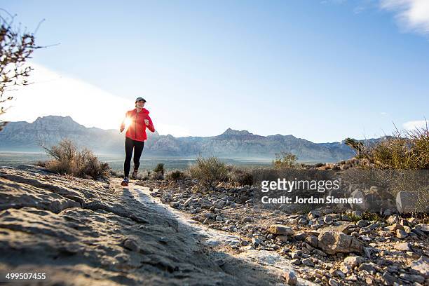 a woman trail running - reserve athlete stock pictures, royalty-free photos & images