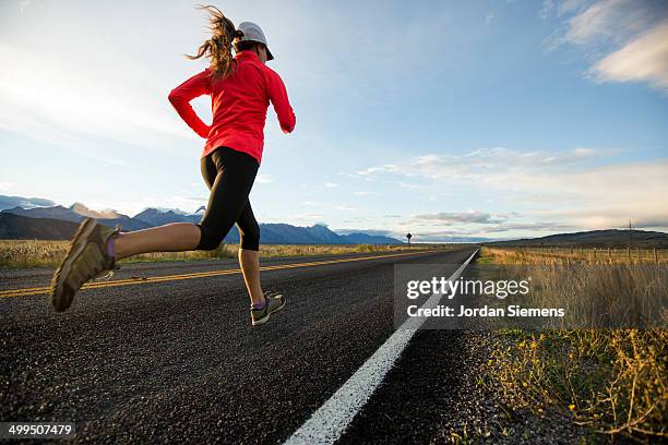 a woman jogging - running shoes sky ストックフォトと画像