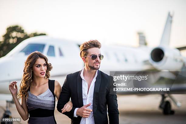 lovely couple at the airport track - rich celebrities stock pictures, royalty-free photos & images