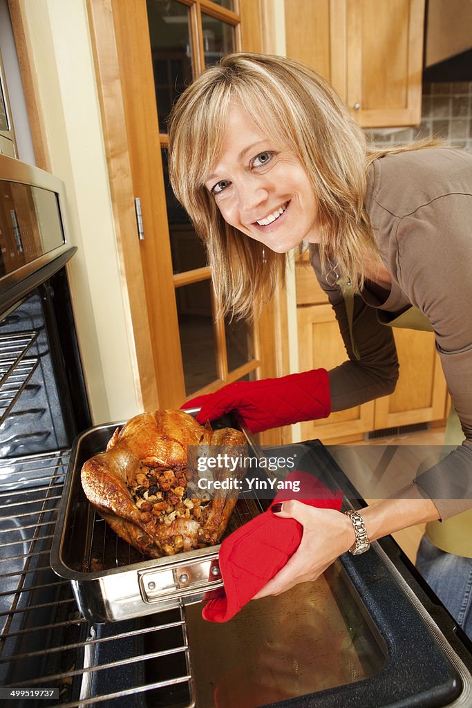 Roasting Thanksgiving and Christmas Turkey in Family Kitchen Vertical