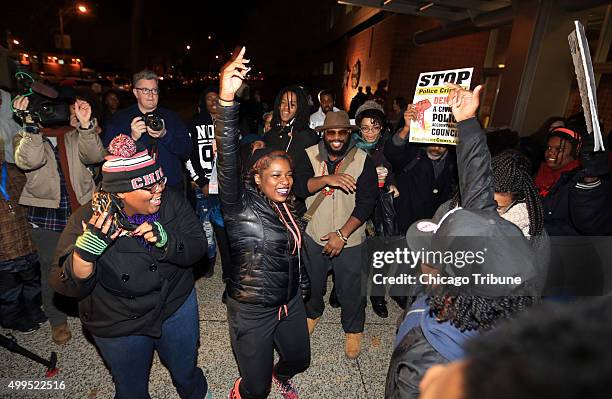 Small group of protesters and activists celebrate outside Chicago Police headquarters on Tuesday, Dec. 1 hours after Chicago Mayor Rahm Emanuel asked...