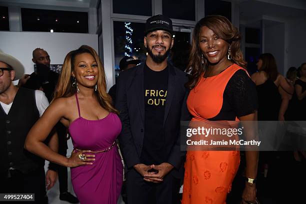 Michelle Madison, Swizz Beatz, and Trina Robinson attend the Opening of Lenny Kravitz FLASH Photography Exhibition at Miami Design District on...