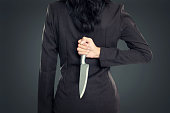 Business woman Holding Knife Behind His Back
