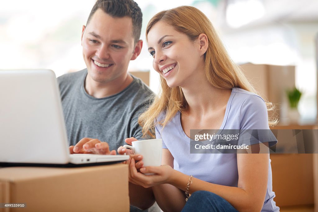 Young couple shopping online for their new home