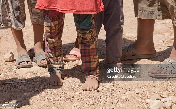 feet of children in idp camp - iraq stock pictures, royalty-free photos & images