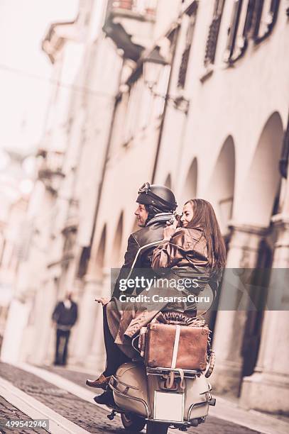 vintage couple with vespa scooter in italy - gorizia stock pictures, royalty-free photos & images