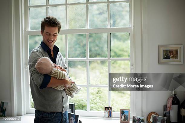 happy father looking at baby - father and baby stockfoto's en -beelden