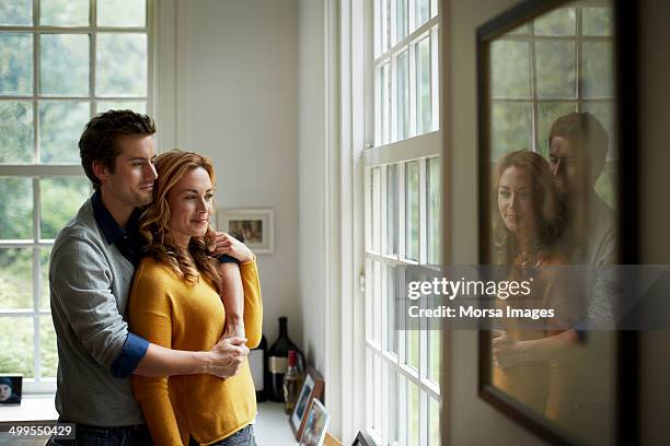 romantic couple in cottage - man hugging woman foto e immagini stock