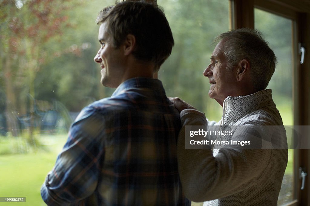 Thoughtful father and son in cottage