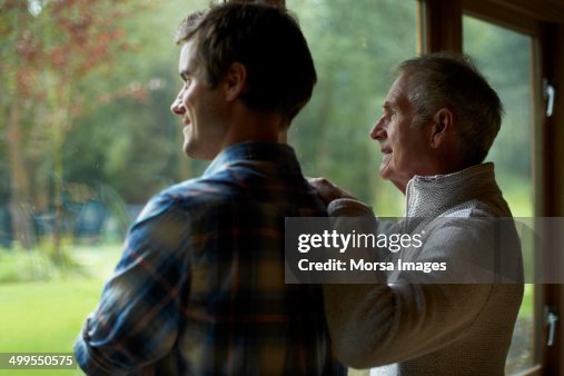 Thoughtful father and son in cottage Thoughtful father and son in cottage