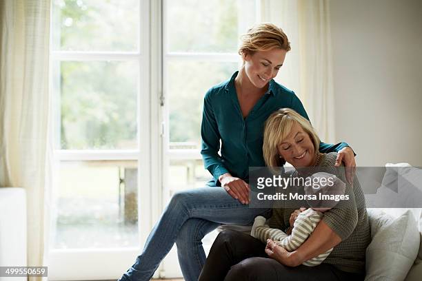 family of three generations in cottage - baby bonding stock pictures, royalty-free photos & images