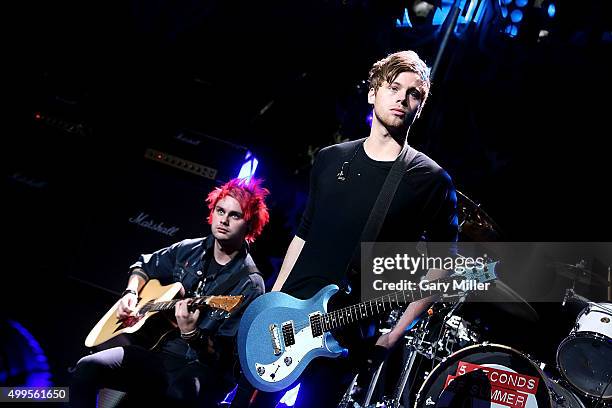 Michael Clifford and Luke Hemmings of 5 Seconds of Summer perform in concert during the iHeart Radio 106.1 KISS FM Jingle Ball at the American...