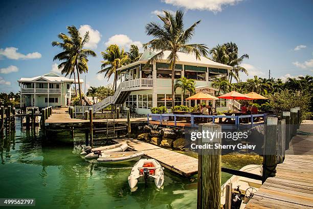 Dinghies line up at a dock beside a tropical restaurant in Marsh Harbour, Abacos, Bahamas