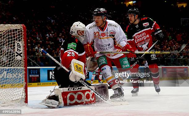 Gustaf Wesslau, goaltender of Koelner stops Daniel Kreutzer of Duesseldorfer EG during the DEL Ice Hockey match between Koelner Haie and...