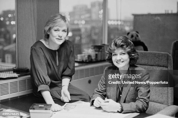 British television broadcasters Carol Barnes and Pamela Armstrong pictured in the offices of ITN in London on 6th December 1984.