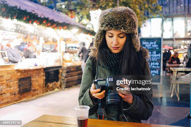 winter portrait of a smiling young woman photographer - girls flashing camera 個照片及圖片檔