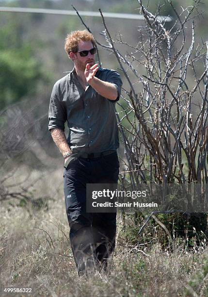 Prince Harry arrives to view the carcass of a rhino slaughtered for its horn in Kruger National Park, during an official visit to Africa on December...