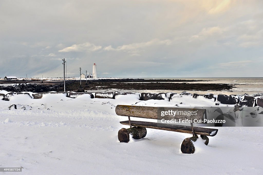 A wooden bench in front of Grotta Lighthouse at Seltjarnarnes, Reykjavik, Iceland