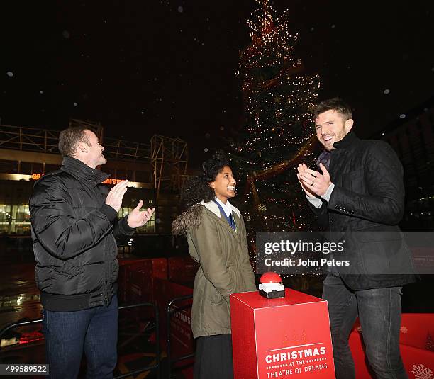 Wayne Rooney and Michael Carrick of Manchester United, with Winta Abreha - a child from a local school in association with the Manchester United...