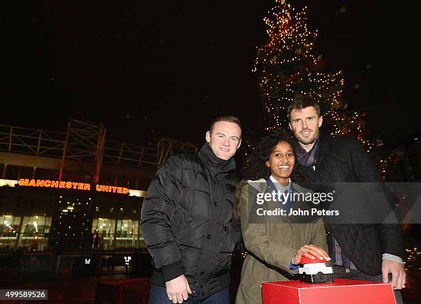 Wayne Rooney and Michael Carrick of Manchester United, with Winta Abreha - a child from a local school in association with the Manchester United...