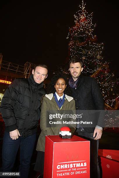 Wayne Rooney and Michael Carrick of Manchester United, with Winta Abreha - a child from a local school in association with the Manchester United...