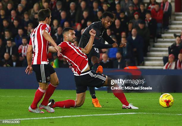 Daniel Sturridge of Liverpool shoots past Steven Caulker of Southampton to score their first goal during the Capital One Cup quarter final match...